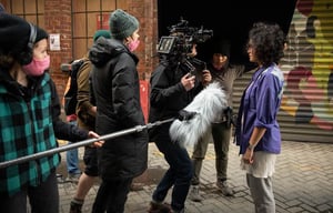 Michelle (DIR.), Crew, Ana (MILLIE) in alleyway. Photo: Provided