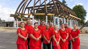 Members of the K'aute Pasifika leadership team, including CE Leaupepe Rachel Karalus (right) in front of the new landmark now taking shape, the Pan Pacific Hub in Hamilton. Photo: NZ Herald