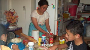 Young Villa with mum and brother in kitchen. Photo: Kolio Lemanu