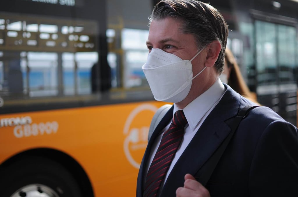 Transport Minister Michael Wood waiting to catch an AirportLink bus to Puhinui Station Interchange on Friday. Photo: Provided