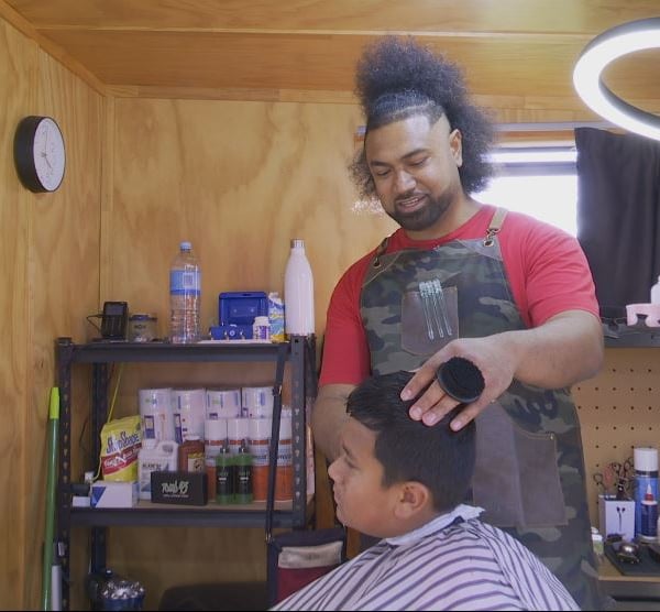 Barber operates tiny shop outside his home to be closer to his children