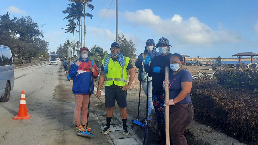 Despite the recent tsunami, locals take to cleaning the capital in good spirits. Photo: Kofeola Marian Kupu
